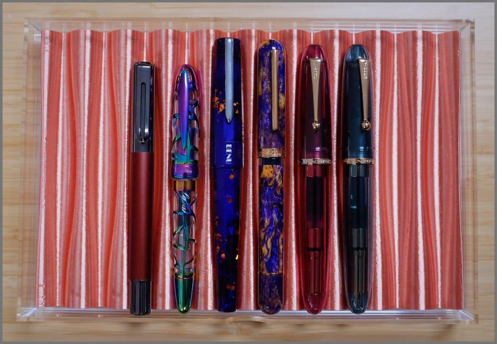 Another acrylic drawer with a light copper-colored 3D-printed tray holding 6 fountain pens of different shapes and colors