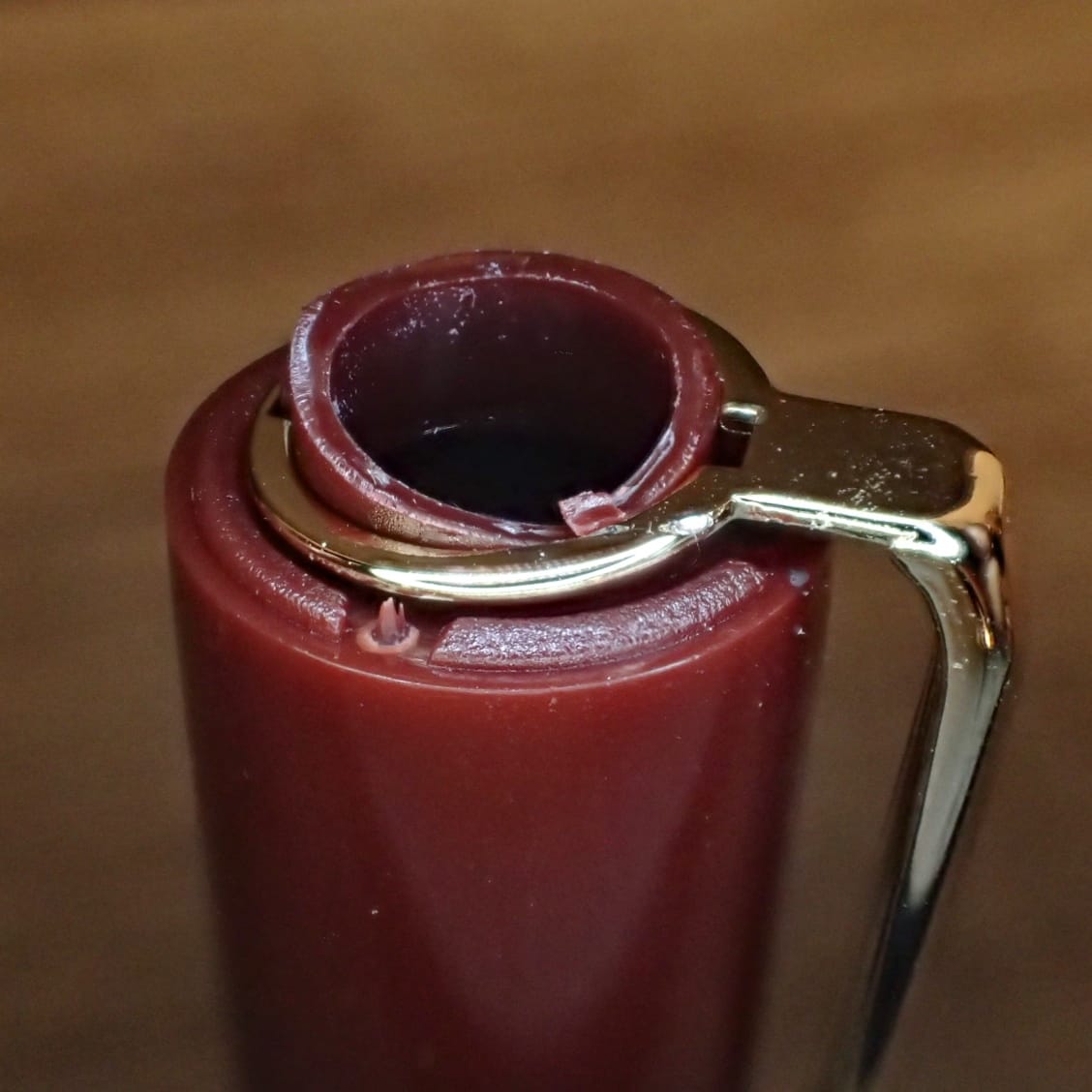 Close-up of the top of the cap showing the broken plastic and the pen clip which is no longer held in place