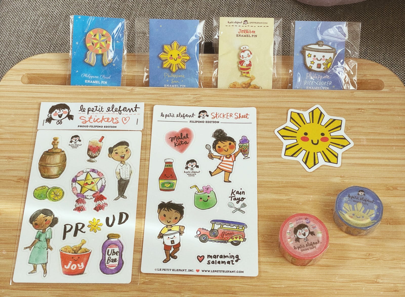 2 sticker sheets of Filipino-themed items, like the star found on the Philippine flag, a jeepney, a parol, coconut drinks. Also 2 washi tapes, 4 enamel pins, and another large Philippine sun sticker. 