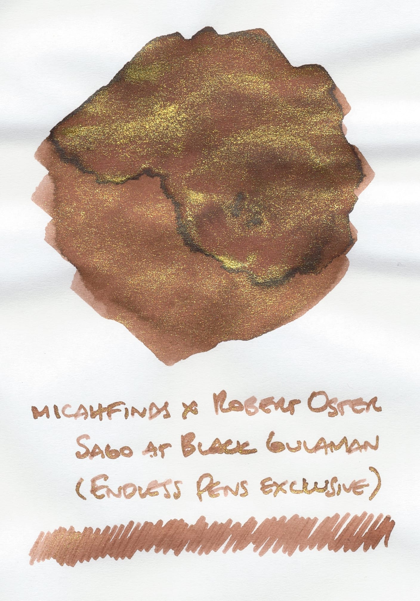 A reddish-brown and gold shimmer fountain pen ink swatch with its name written underneath: "micahfinds x Robert Oster Sago at Black Gulaman (Endless Pens exclusive)" and a long scribble underneath the text.