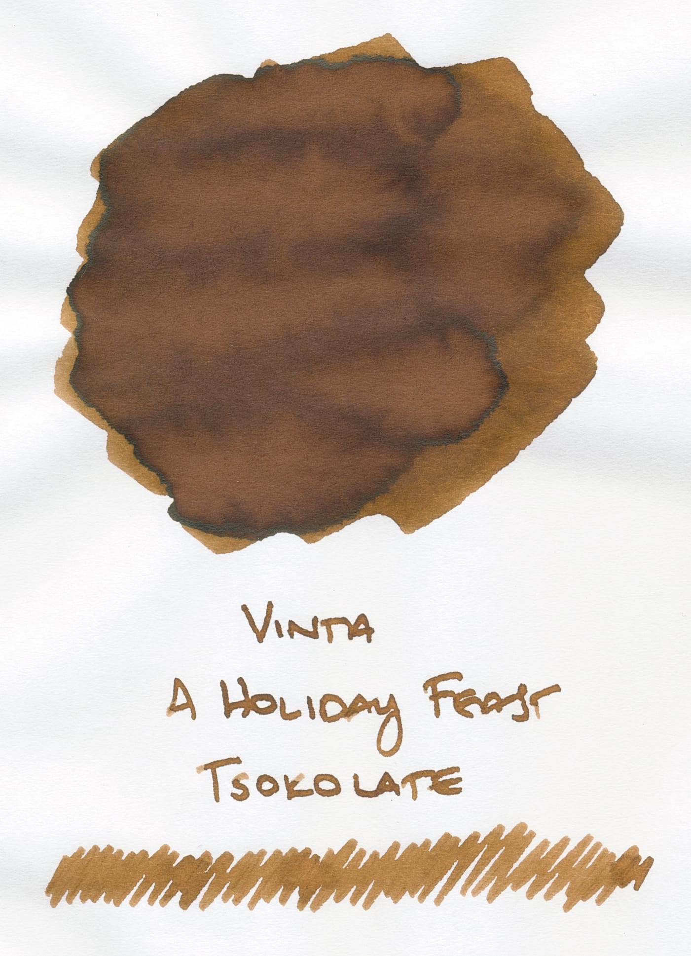 Swatch of a brown fountain pen ink labeled, "Vinta A Holiday Feast, Tsokolate" under the swatch, and a long scribble under the label to show what the ink looks like from a fountain pen nib.