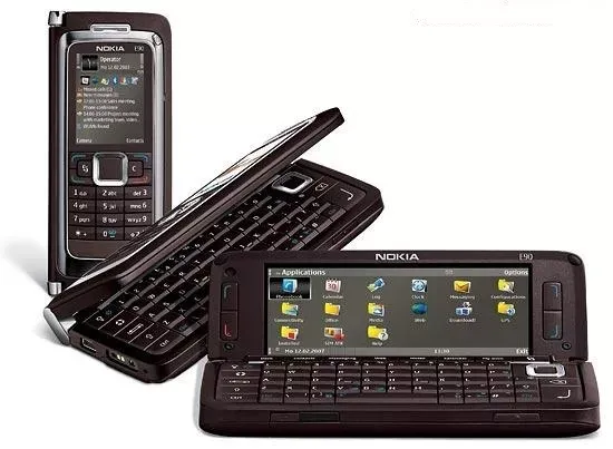 Multiple views of the Nokia E90 Communicator phone, vertically showing outer screen and keypad, partially open, and fully open showing wide but short inner screen and QWERTY keyboard