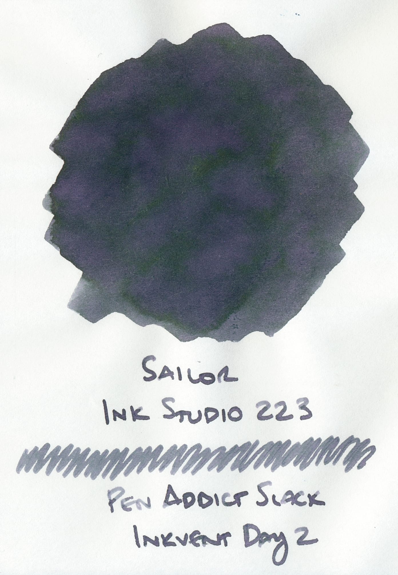 Swatch of a blue-gray fountain pen ink that has some visible areas of pink and purple undertones