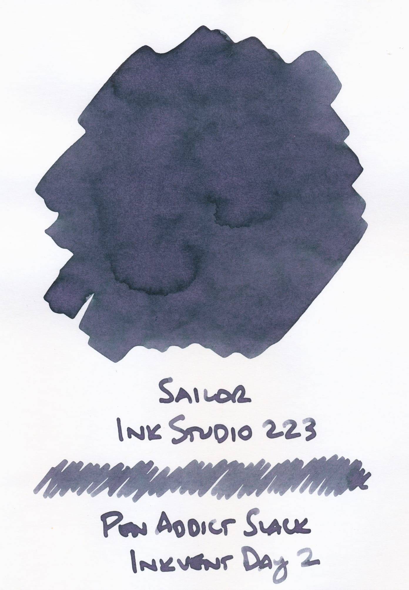 Swatch of a blue-gray fountain pen ink that has some visible areas of pink and purple undertones