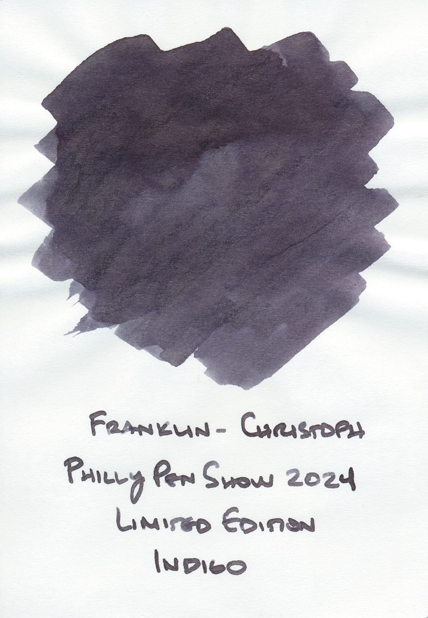 Ink swatch of a medium to dark gray with a purple undertone labeled "Franklin-Christoph Philly Pen Show 2024 Limited Edition Indigo"