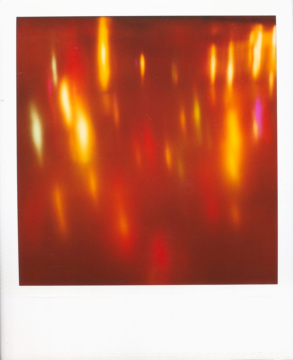 Scan of a Polaroid of a dreamy abstract image of Christmas lights reflecting off of a surface