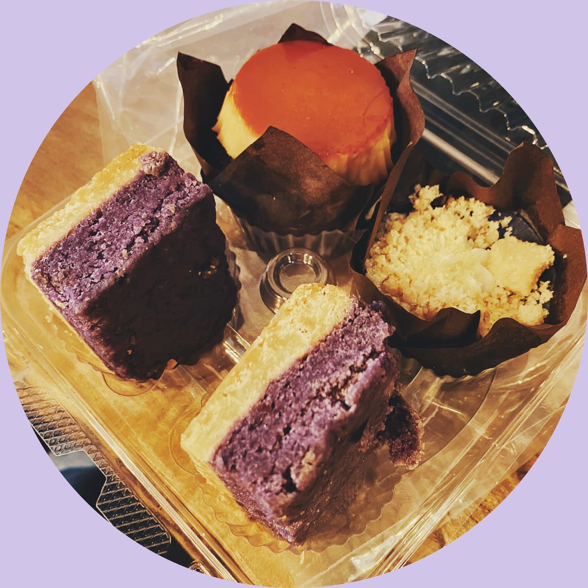 Overhead picture of various Filipino ube desserts in a plastic box