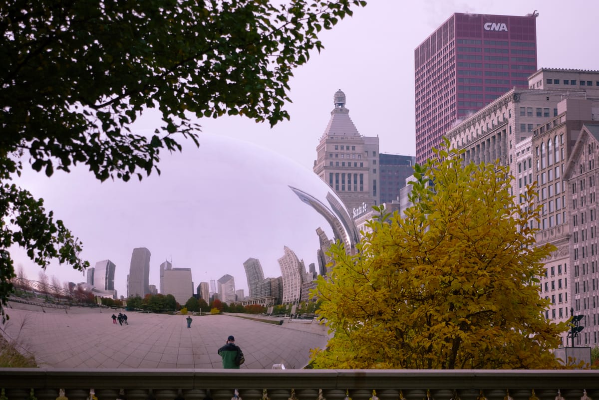 View of the "Bean" sculpture (the Cloud Gate) at Millennium Park in Chicago reflecting nearby buildings