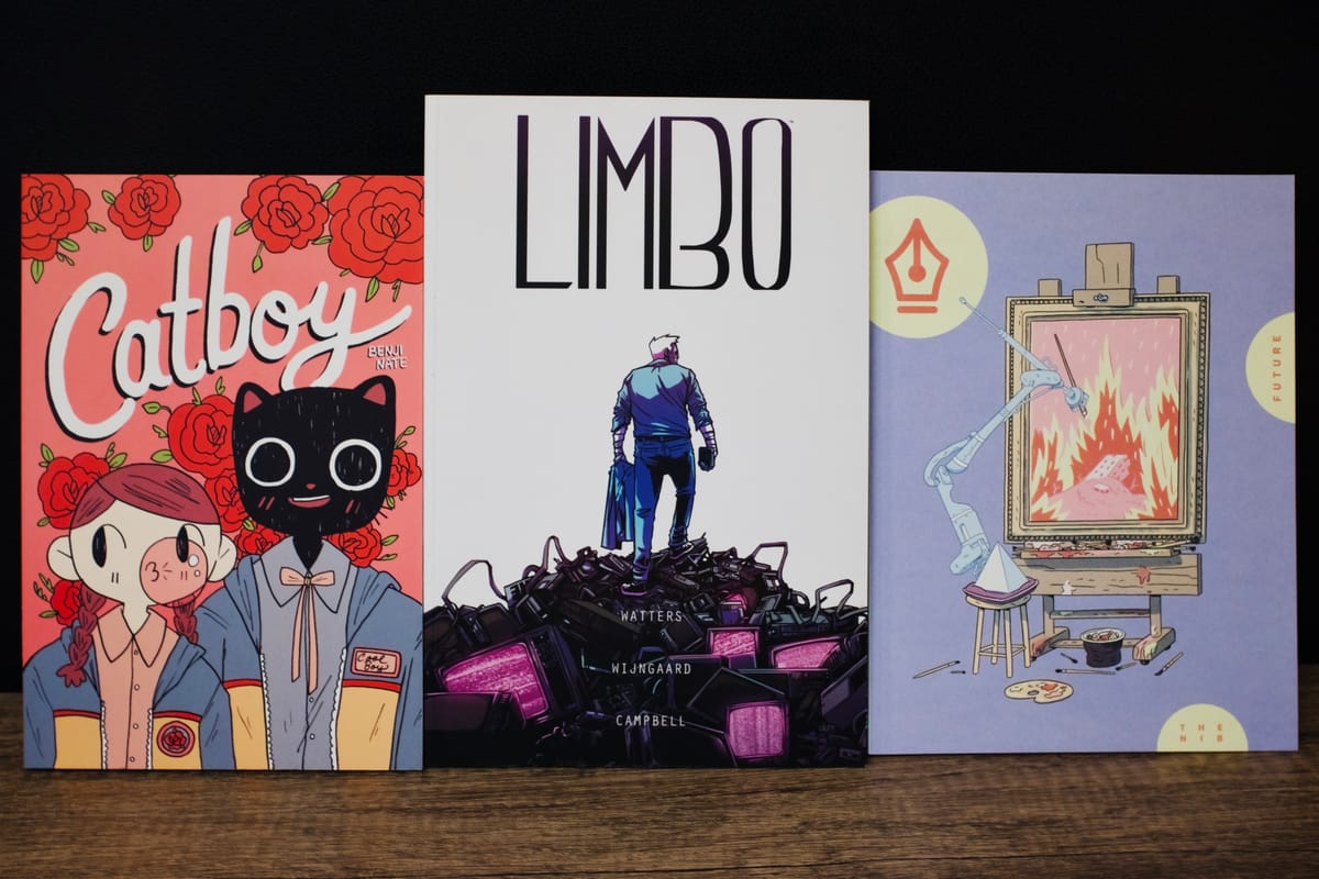 3 paperbacks against a black background and wooden table-top surface: Catboy, Limbo, and an issue of The Nib