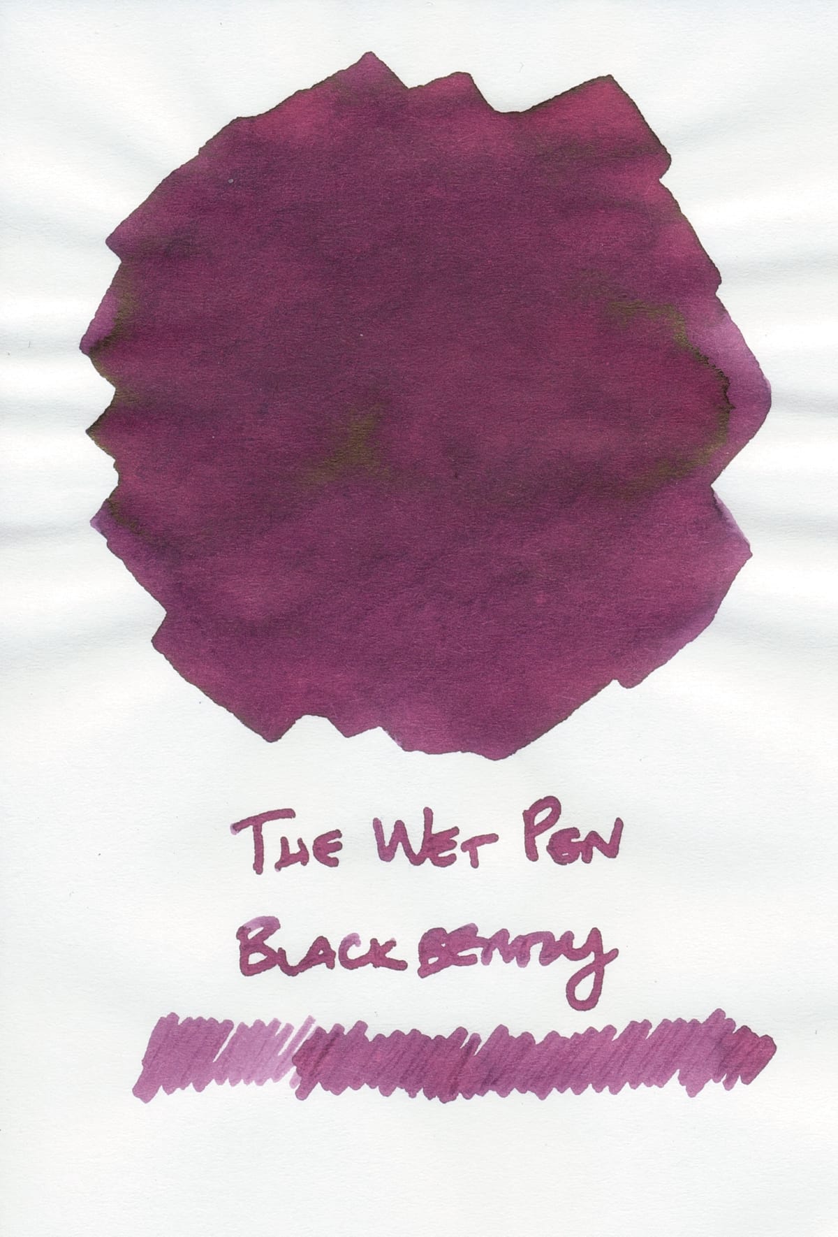 Ink swatch of a medium-dark berry shade, its name written underneath, and an additional pen squiggle