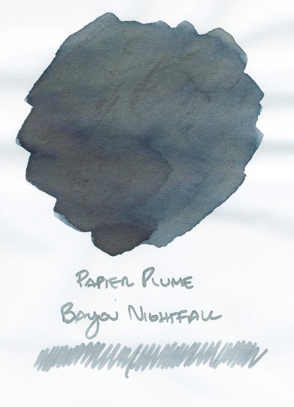 Fountain pen ink swatch on white paper, handwritten label Papier Plume Bayou Nightfall underneath