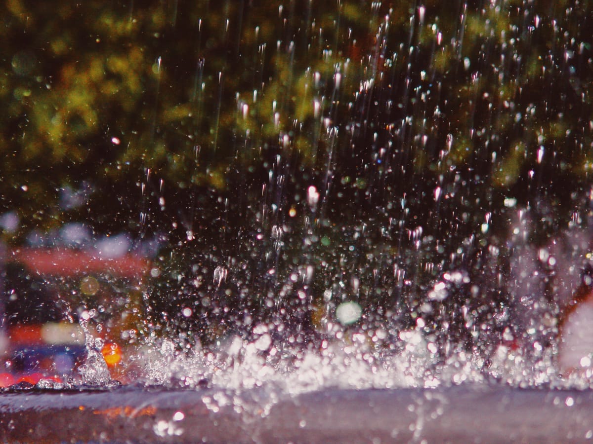 Abstract close-up picture of water droplets splashing in a fountain, scattered in the frame