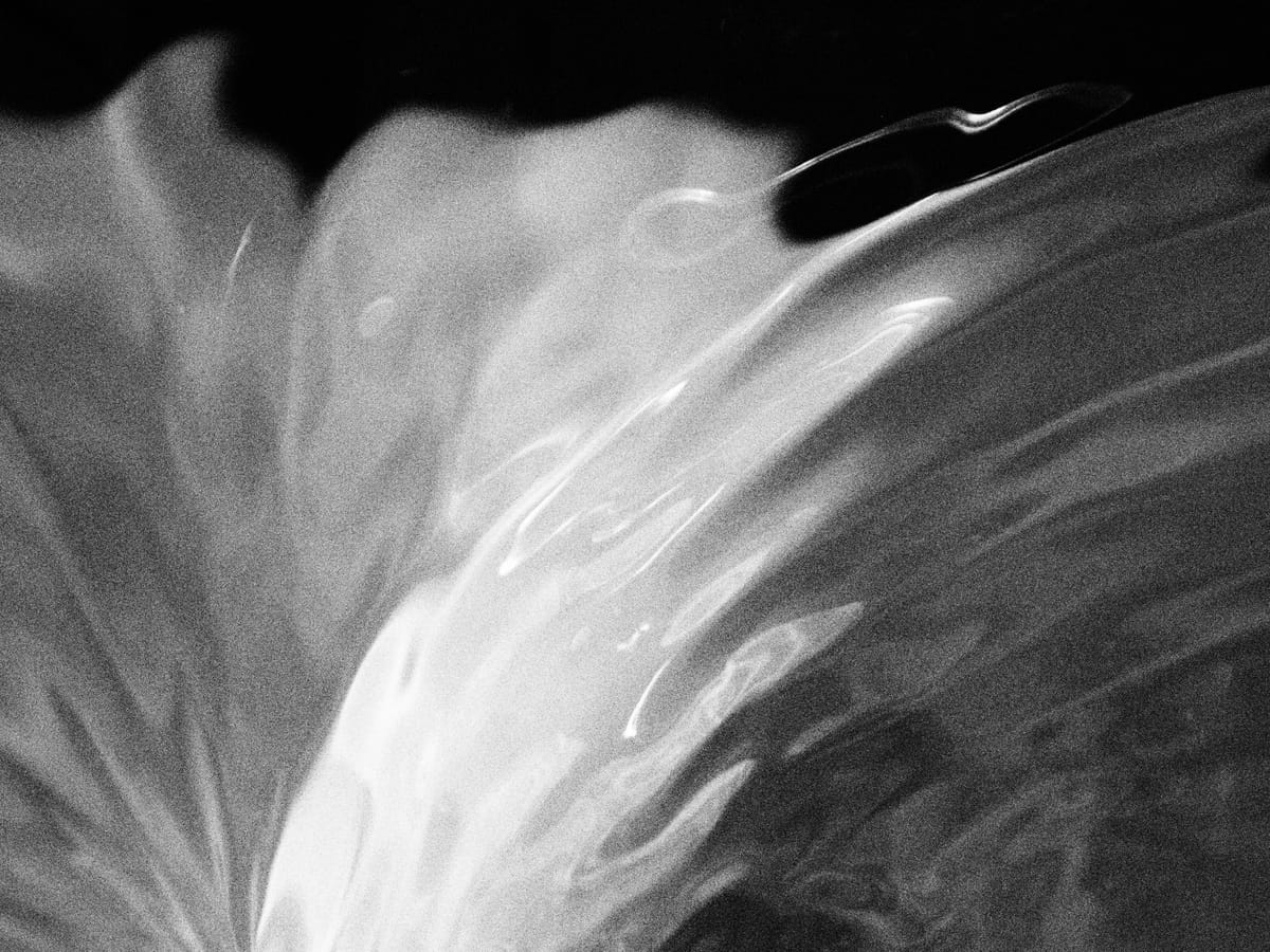 Abstract grainy black and white image of water contours in a fountain vortex