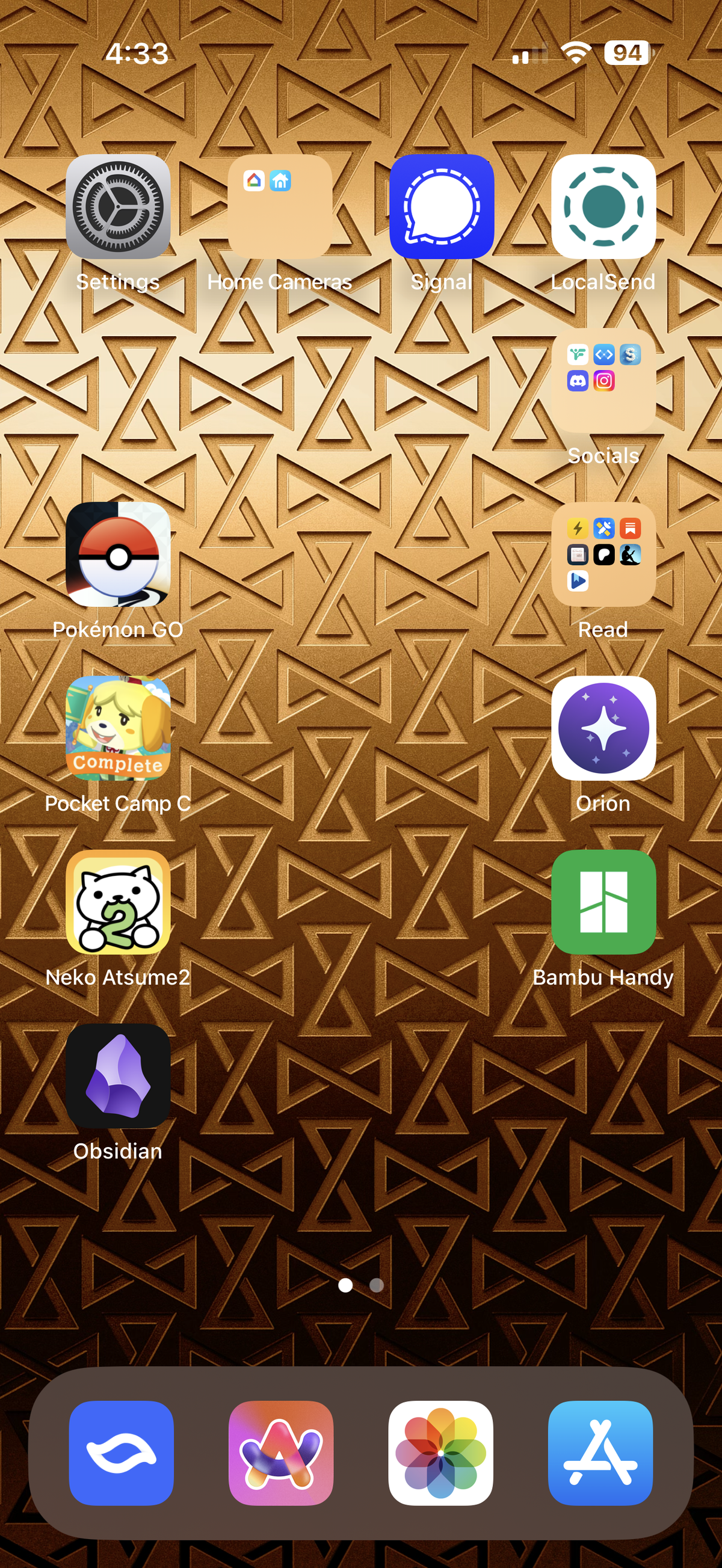 Screenshot of an iPhone home screen, showing various app and game icons over a golden gradient wallpaper of TVA logos